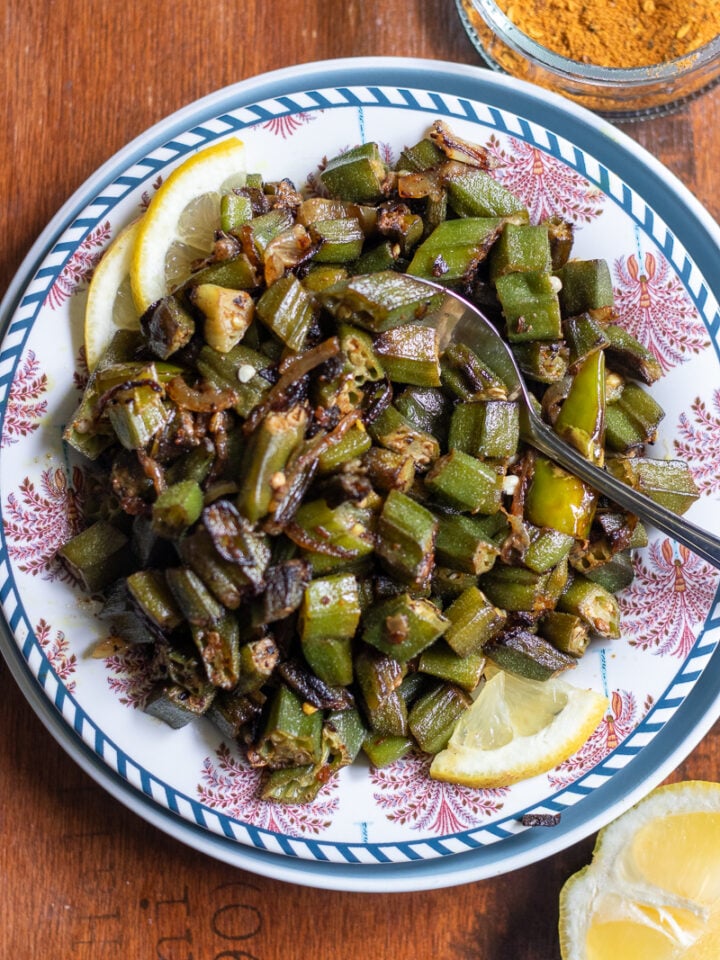 top down view of achari bhindi on a wooden tray