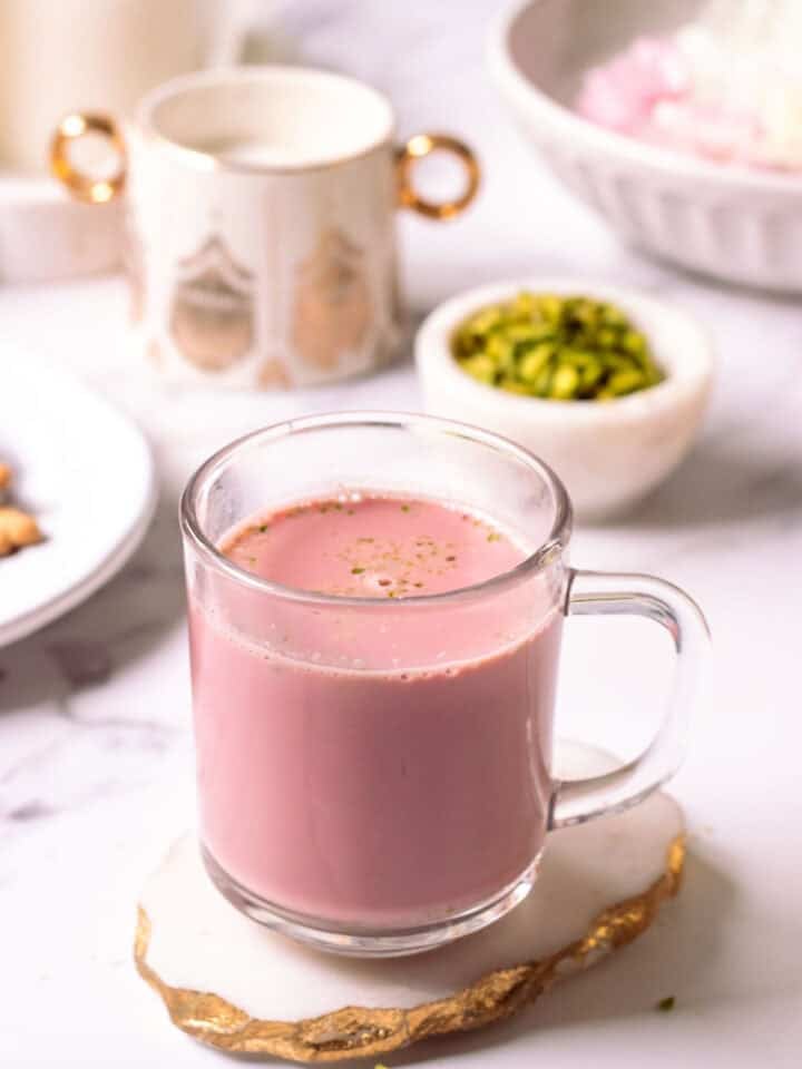 Kashmiri Chao in a glass mug on a coaster with a golden edge