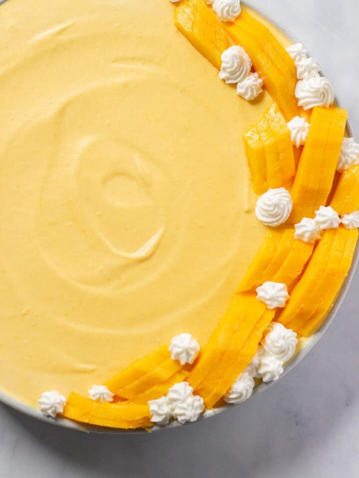Easy Mango Mousse decorated with mangoes and whipped cream