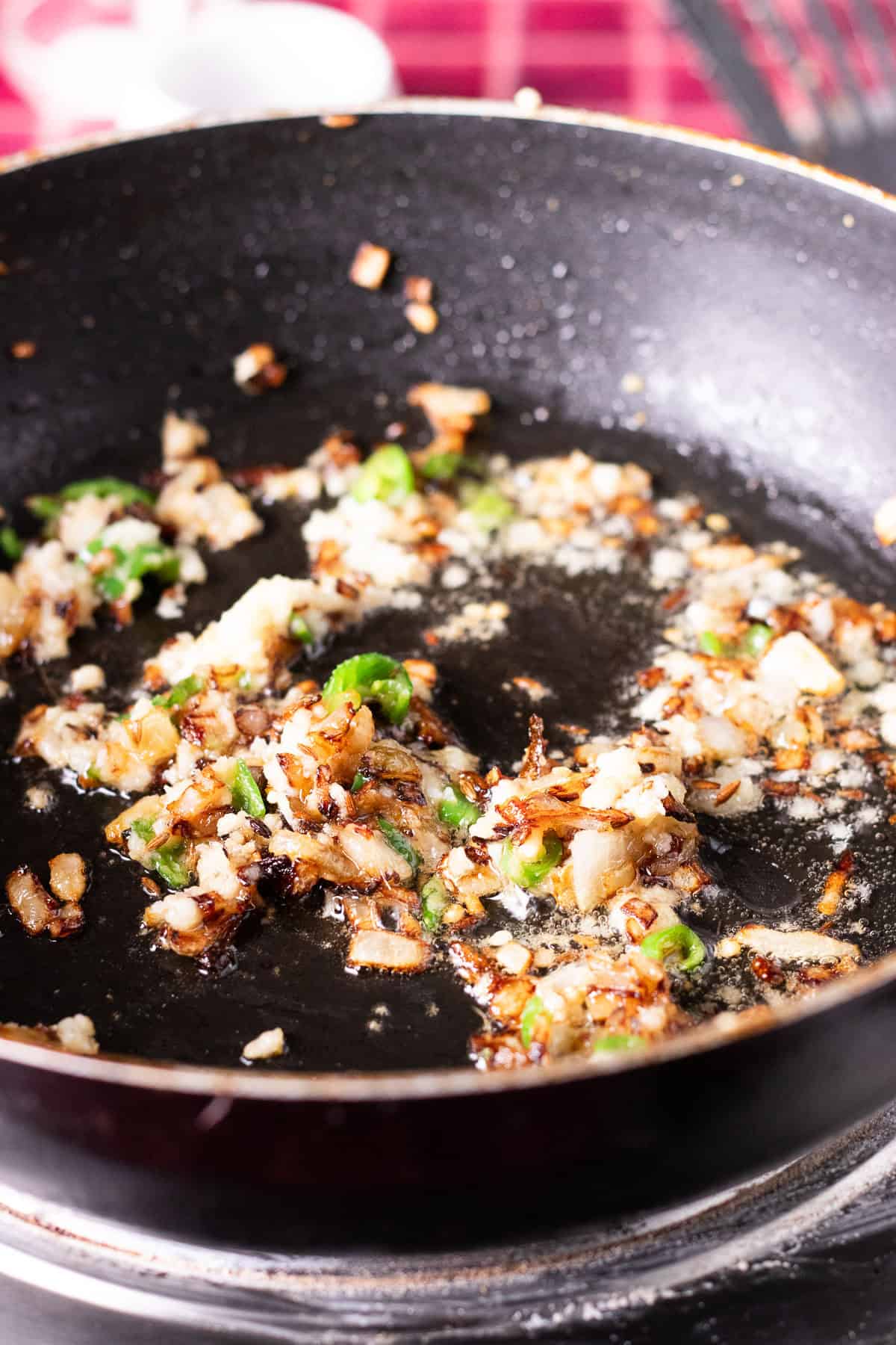 ginger garlic and onions sauteeing in a wok