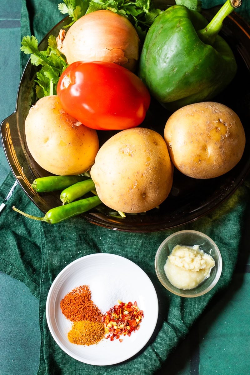 top down view of ingredients for Aloo Simla Mirch Sabzi 